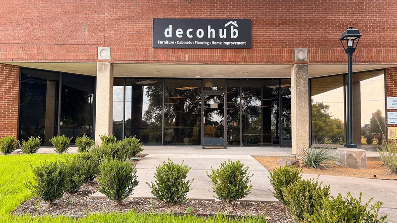 Decohub showroom entrance with store sign and Suite 100 door in Plano