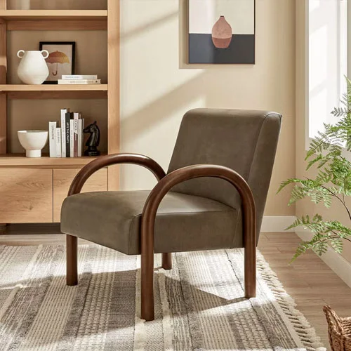 Upholstered accent chair with curved wood arms in a warm living room