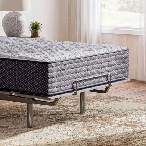 Quilted mattress displayed on an adjustable base in a bright bedroom