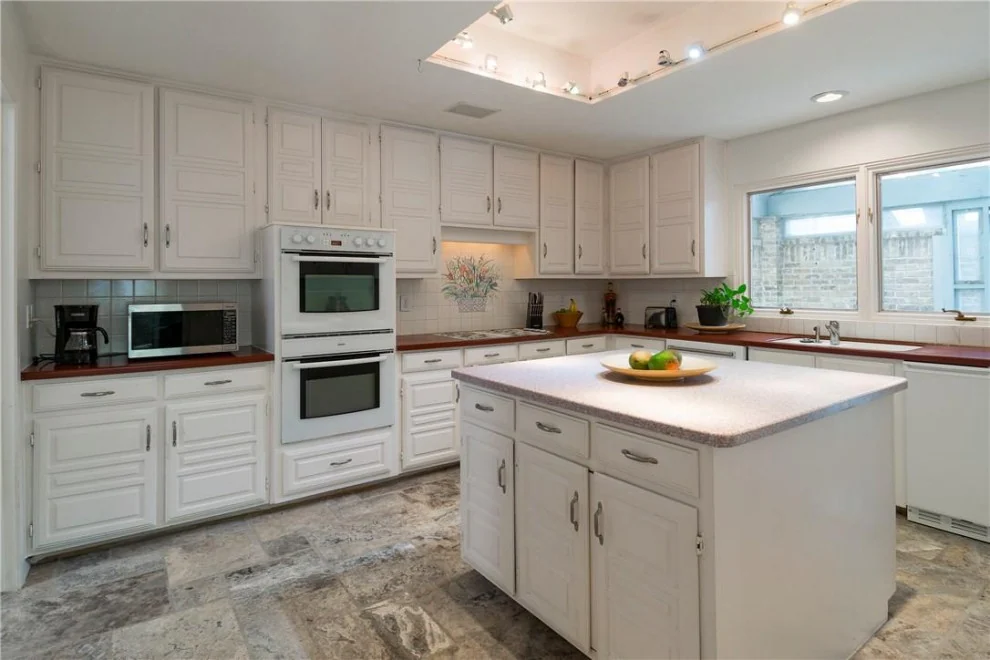 Charleston White kitchen with a central island and decorative cabinet moulding